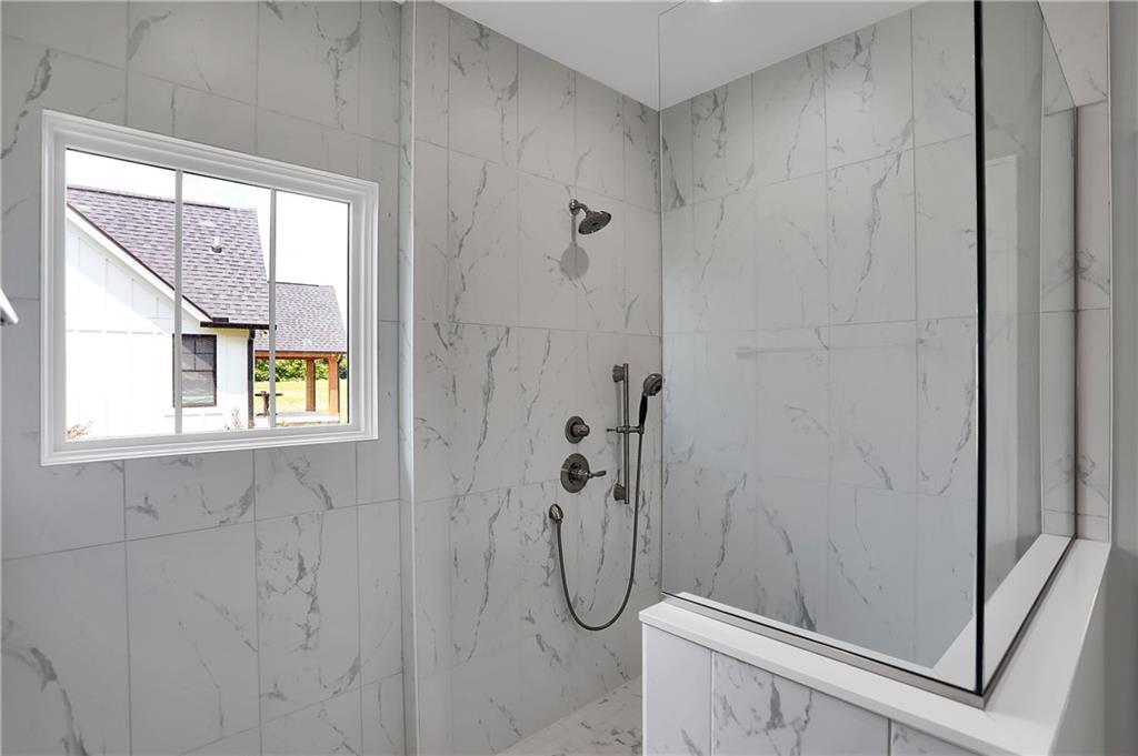 Walk in marble shower designed and created by Dave Sego Builders, Inc. in Greenfield, IN