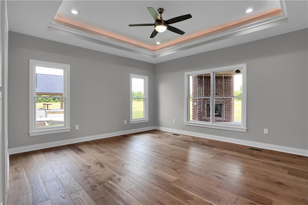 Wood floor room with gray walls, three windows, and a depressed ceiling designed and created by Dave Sego Builders, Inc. in Greenfield, IN